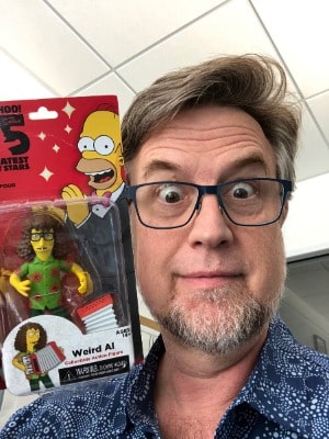 Picture of Dan Povenmire by wearing blue shirt.